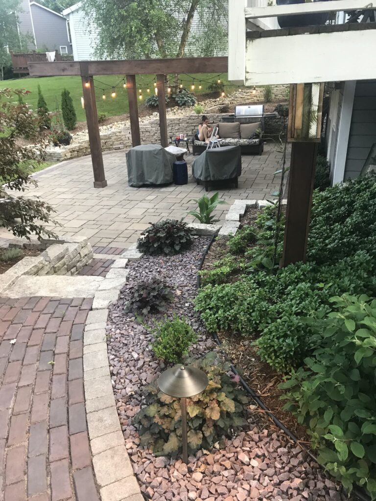 Backyard patio with string lights and seating area.